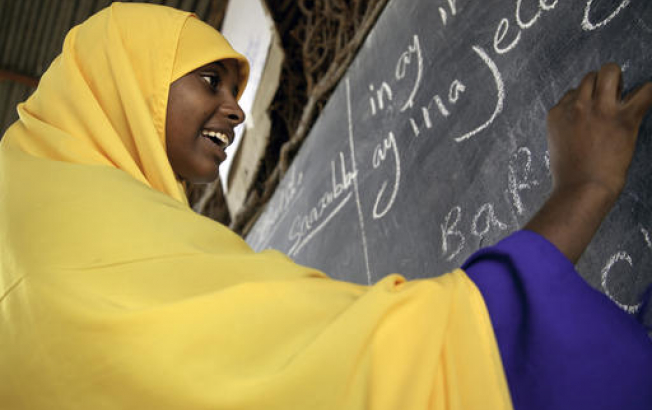 A student writes on the blackboard at Qansahley Primary School in Dollow town, Somalia.
